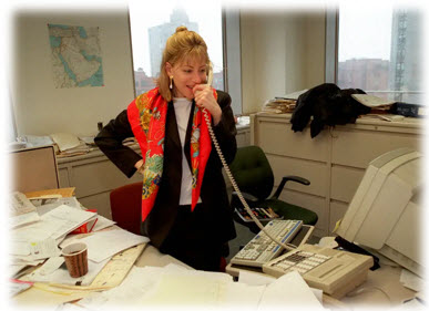 Photo of a professional working woman in an office in early 1990s. No work-life balance here.