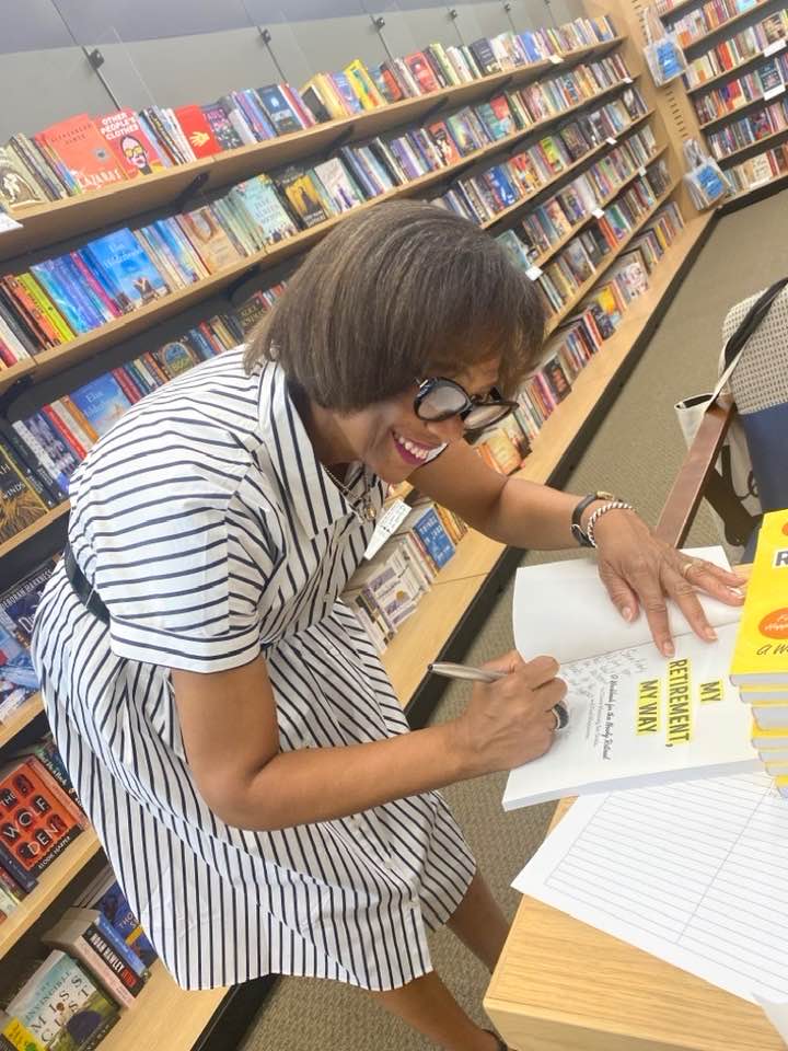 Photo of Veronica McCain at her book signing - realizing one of her retirement dreams
