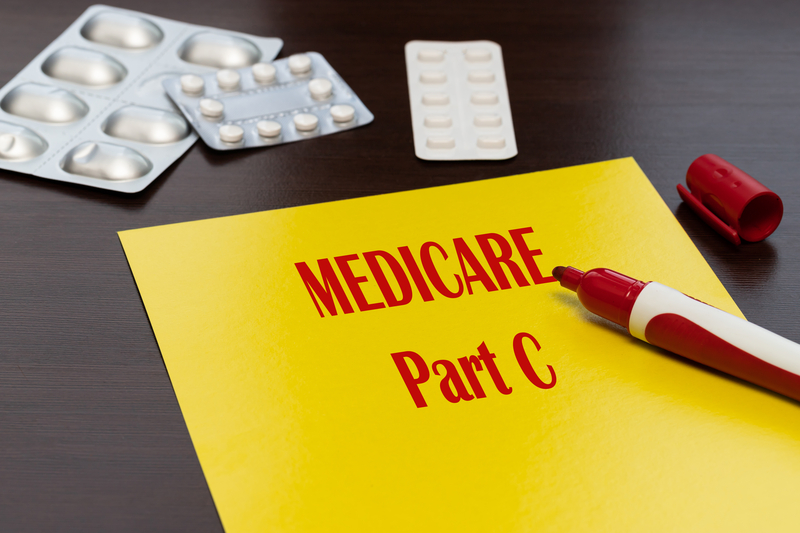 Yellow paper with red writing that reads Medicare Part C
