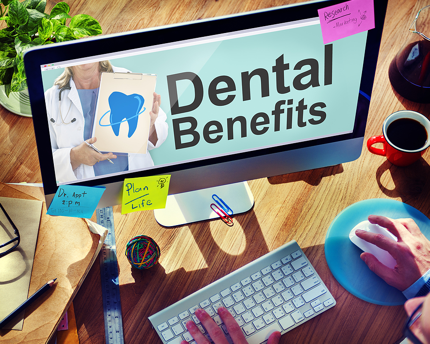laptop with person researching dental plans and Medicare